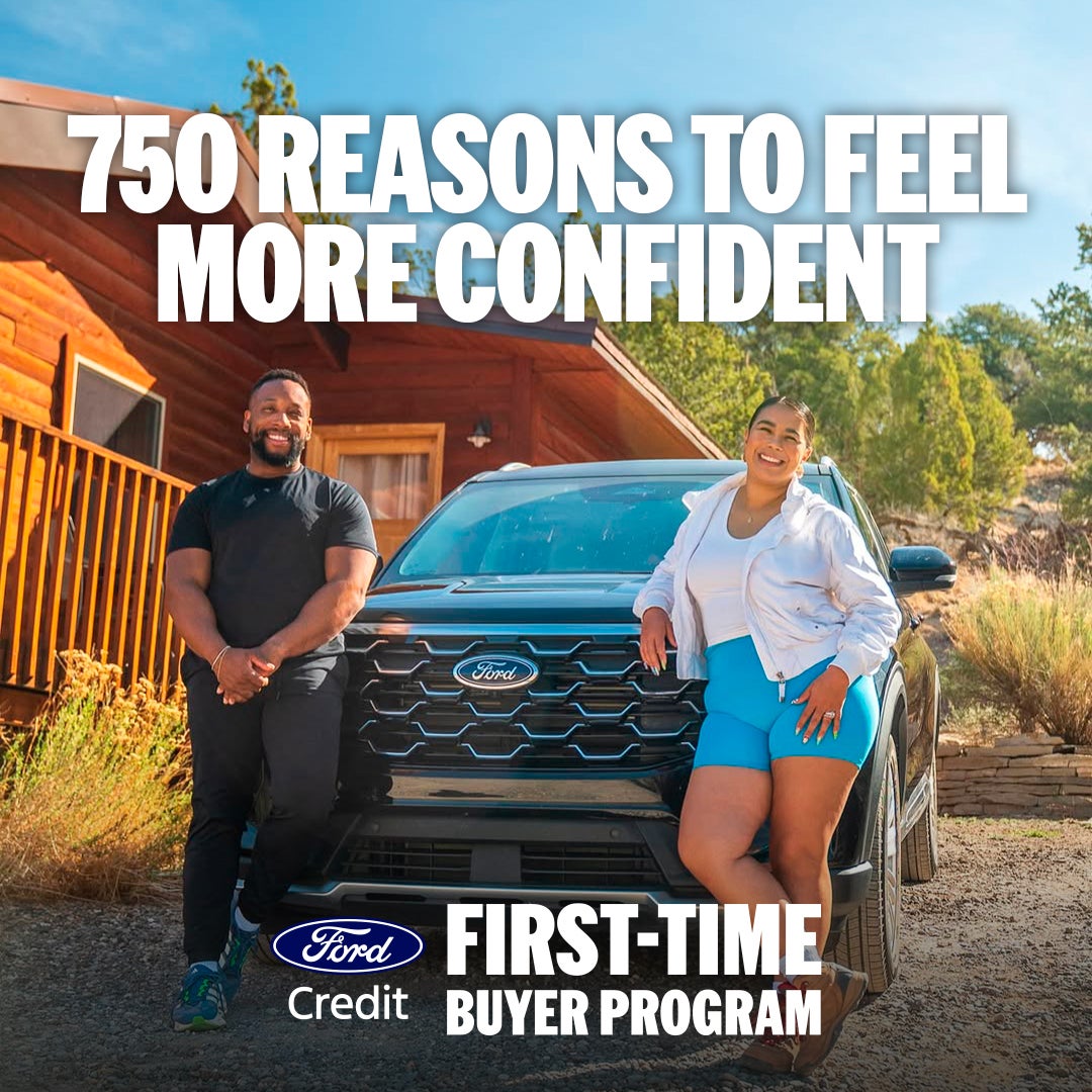 First-time Ford buyers standing with an eligible Ford vehicle