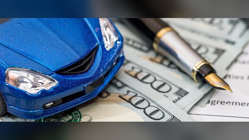 Model car, pen and lease agreement, comparing Ford lease deals near Santa Fe, NM